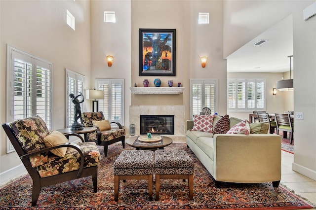 tiled living room with a healthy amount of sunlight and a high ceiling