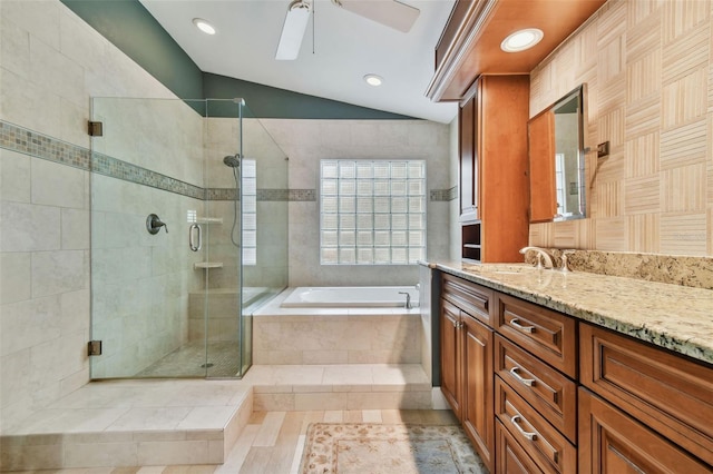 bathroom with lofted ceiling, vanity, ceiling fan, and plus walk in shower