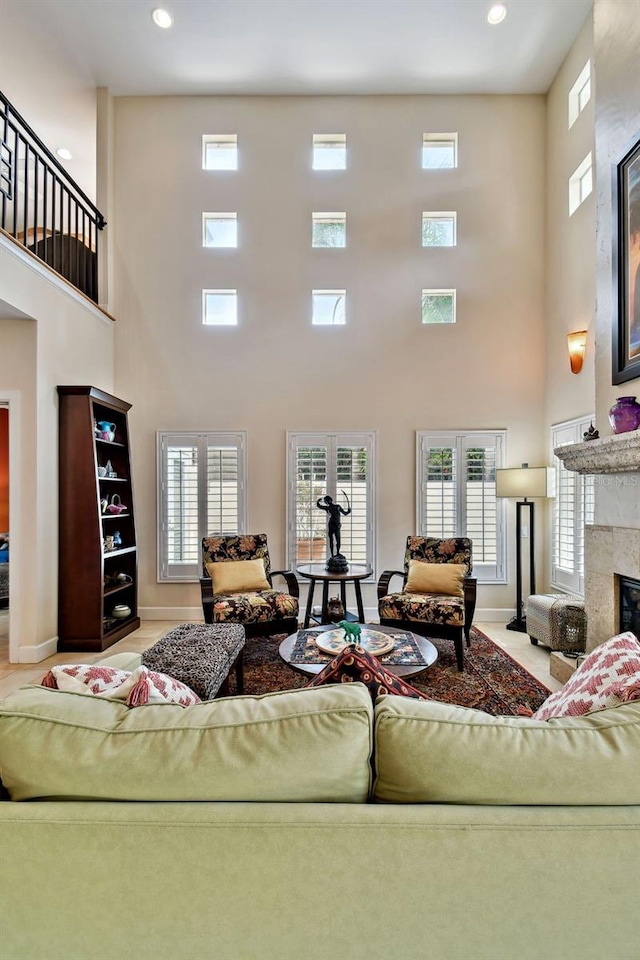 living room featuring a high end fireplace and a towering ceiling