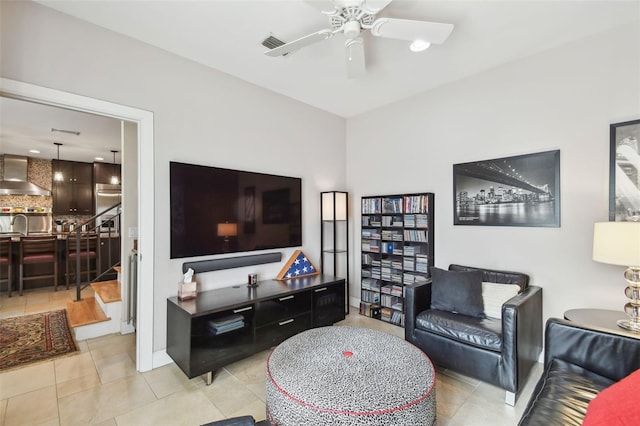 tiled living room with ceiling fan