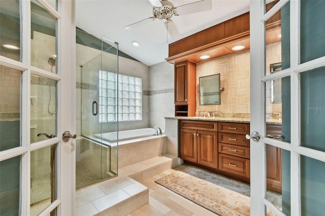 bathroom with plus walk in shower, vaulted ceiling, french doors, and vanity