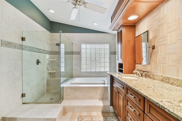 bathroom featuring lofted ceiling, tile patterned floors, vanity, ceiling fan, and separate shower and tub