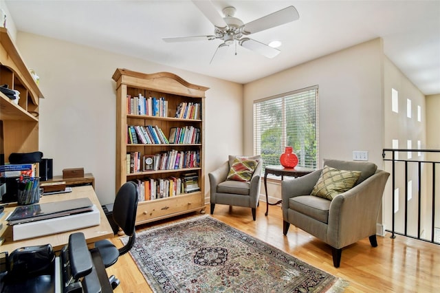 office space with ceiling fan and light hardwood / wood-style flooring