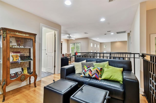 living room featuring ceiling fan and light hardwood / wood-style flooring