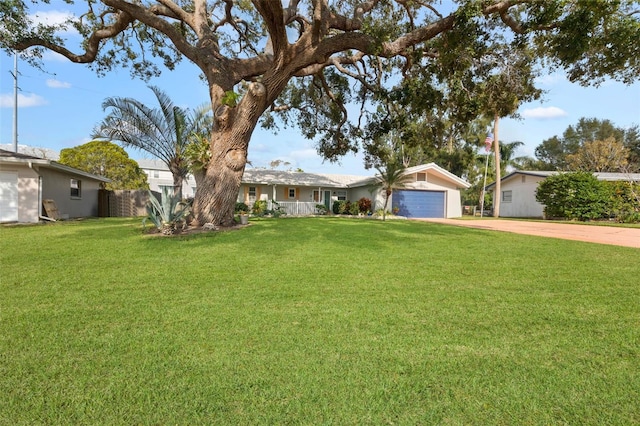 ranch-style house featuring a garage and a front lawn