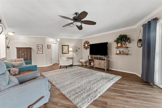 living room featuring ceiling fan, hardwood / wood-style floors, and ornamental molding