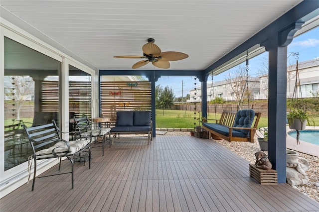 sunroom featuring ceiling fan