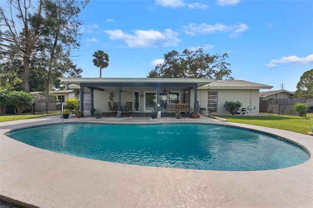 view of swimming pool with a lawn and a patio area