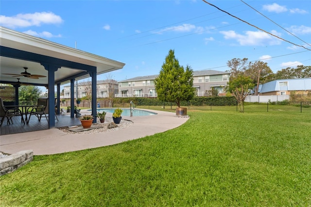 view of yard featuring a patio, a fenced in pool, and ceiling fan