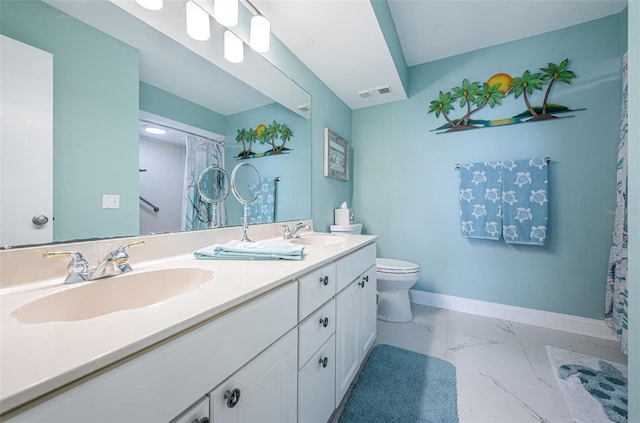 bathroom featuring toilet and vanity