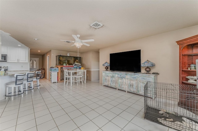 tiled living room with ceiling fan