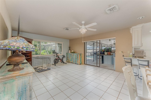 interior space featuring white cabinetry, ceiling fan, and light tile patterned flooring