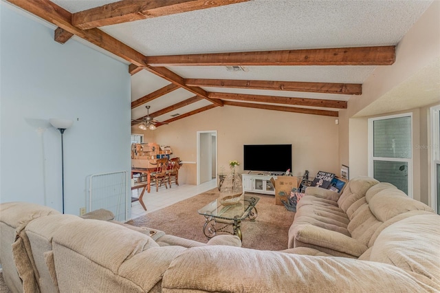 tiled living room featuring ceiling fan, vaulted ceiling with beams, and a textured ceiling