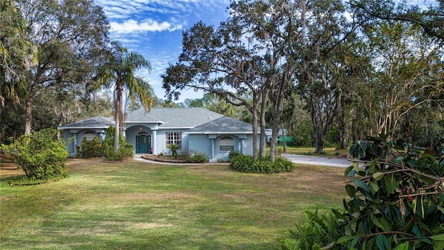 ranch-style home with a front yard