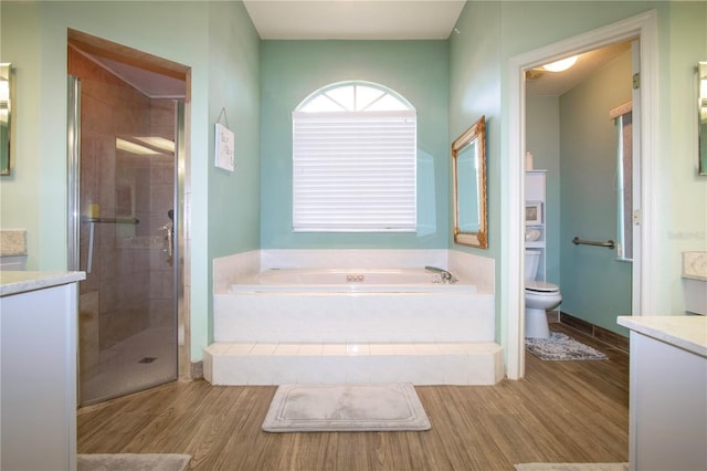 full bathroom featuring separate shower and tub, vanity, wood-type flooring, and toilet