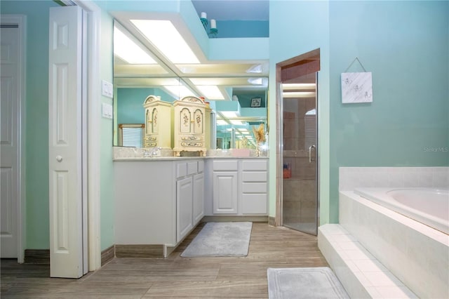 bathroom with vanity and shower with separate bathtub