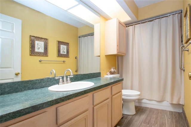 full bathroom featuring shower / tub combo, vanity, hardwood / wood-style flooring, and toilet