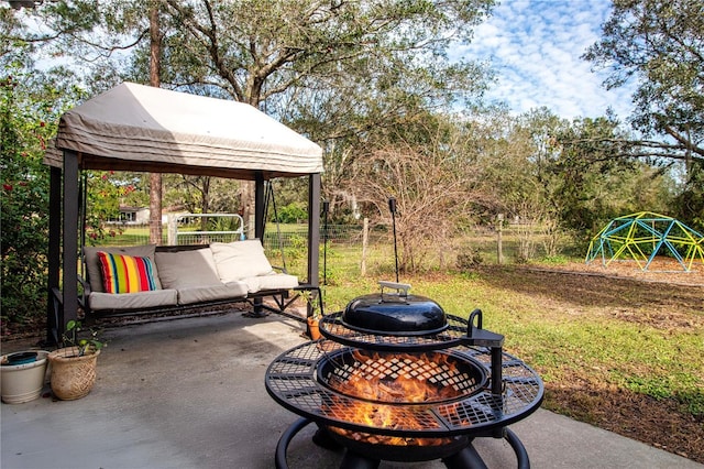 view of patio / terrace with a gazebo and a fire pit