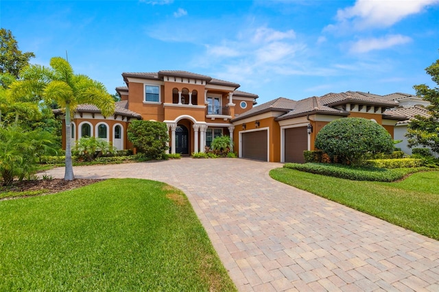 mediterranean / spanish house with a balcony and a front yard