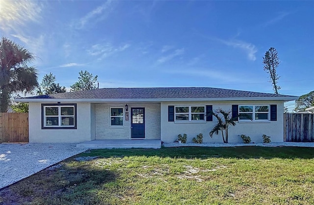 ranch-style home featuring a patio area and a front lawn