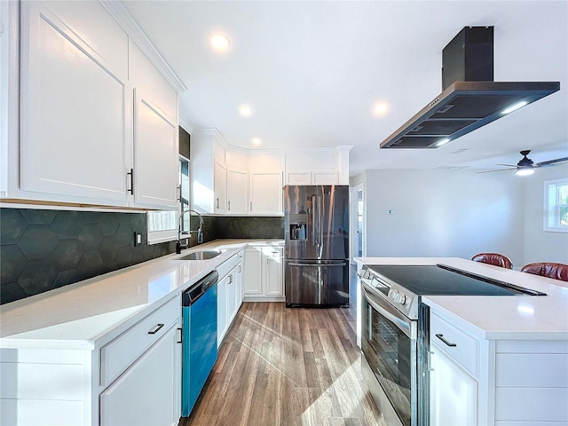 kitchen with exhaust hood, sink, decorative backsplash, white cabinetry, and stainless steel appliances