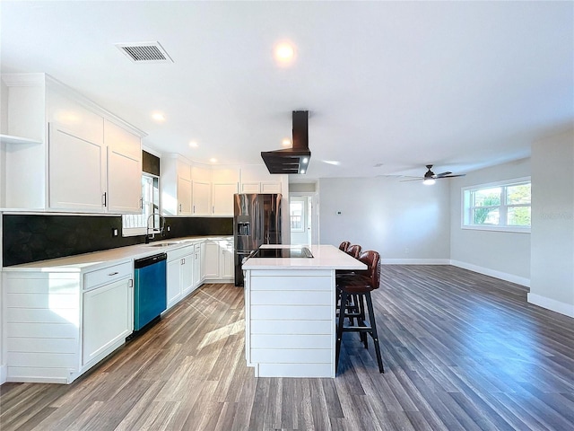 kitchen featuring white cabinetry, a center island, ceiling fan, stainless steel appliances, and sink