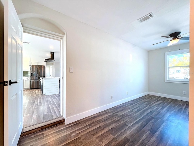 unfurnished room featuring ceiling fan and dark wood-type flooring