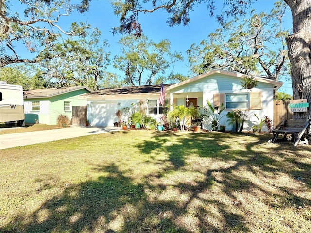 back of house featuring a lawn and a garage