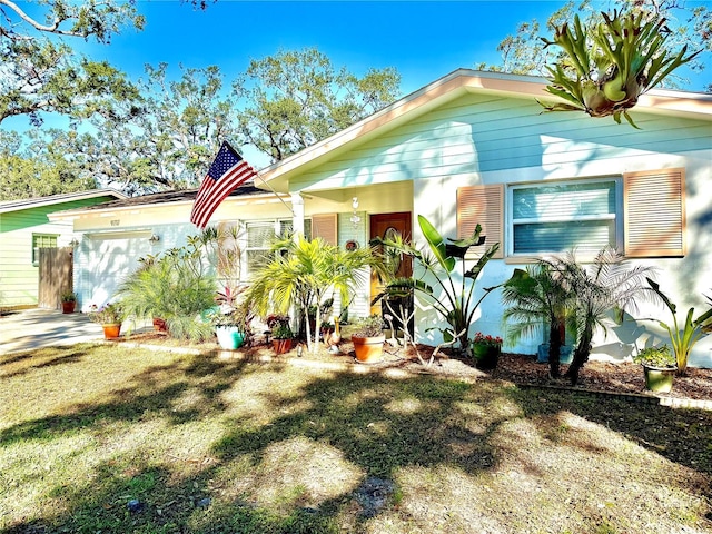 view of front facade with a garage and a front lawn