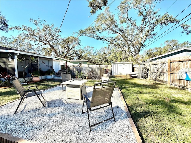 view of yard with a storage unit, a patio, and an outdoor fire pit