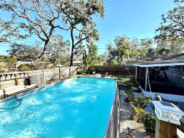 view of swimming pool with a sunroom