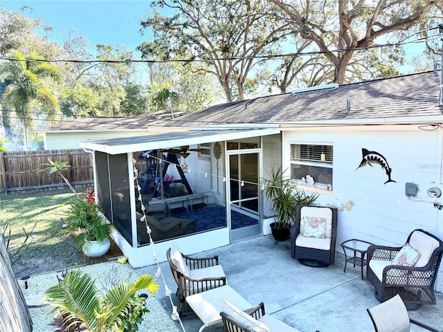 rear view of house featuring a sunroom and a yard