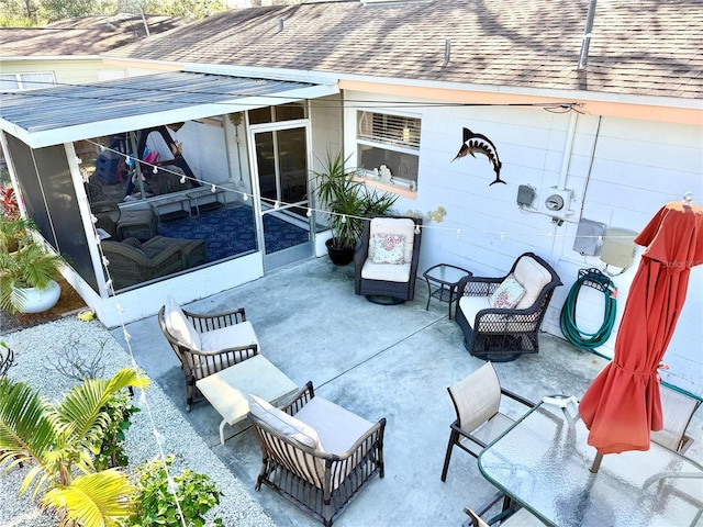 view of patio featuring a sunroom