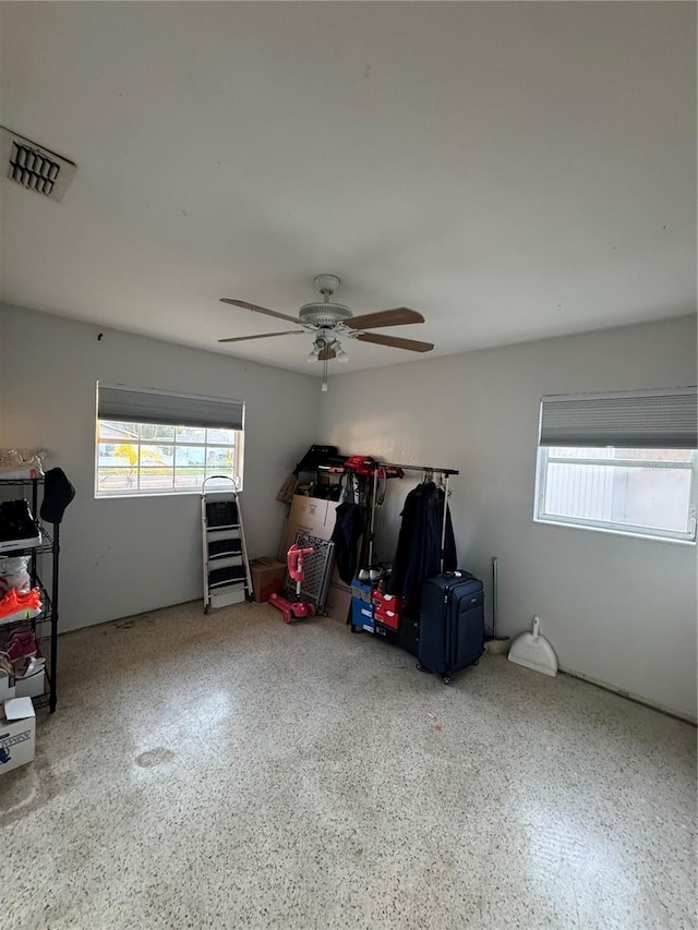 interior space with ceiling fan