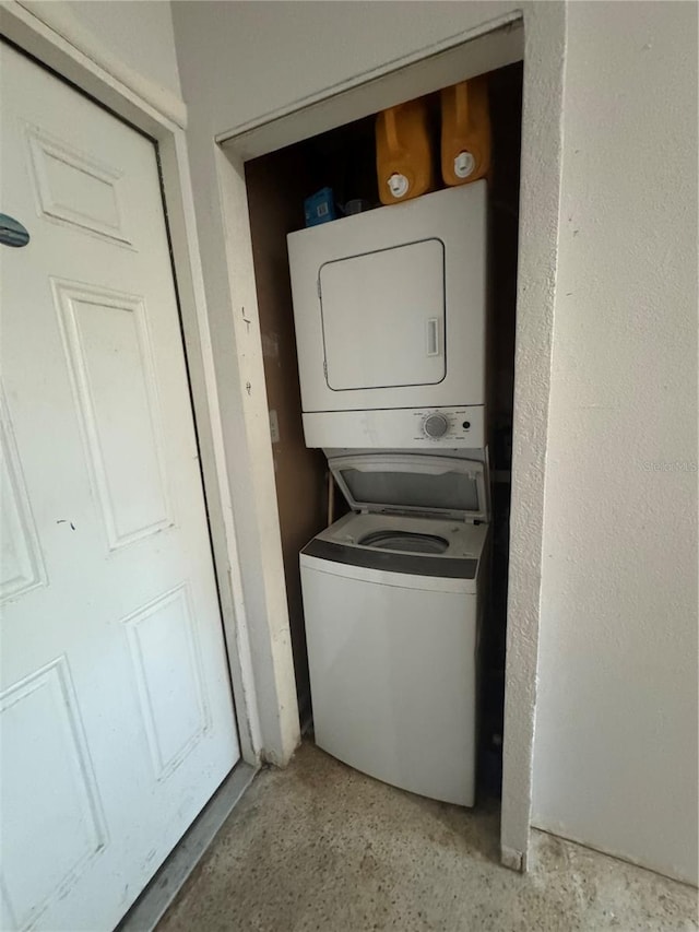 laundry area with stacked washer / dryer