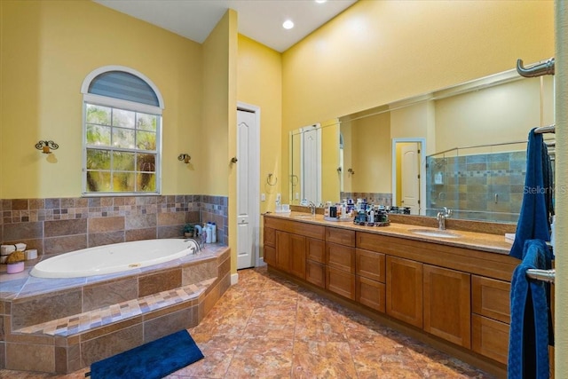 bathroom featuring separate shower and tub, tile patterned flooring, and vanity