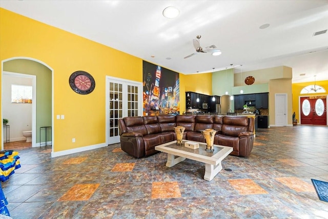 living room with ceiling fan and french doors