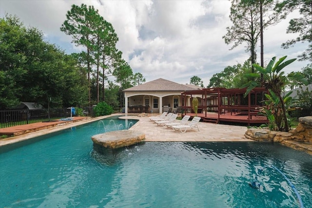 view of swimming pool featuring pool water feature, an outdoor bar, and a deck