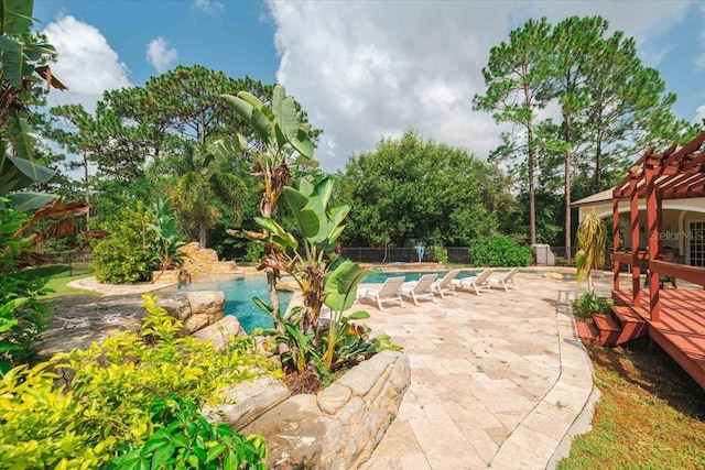 view of patio / terrace with a fenced in pool