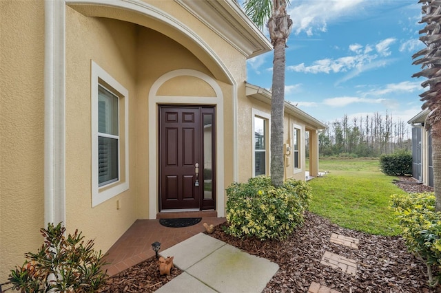 doorway to property with a yard