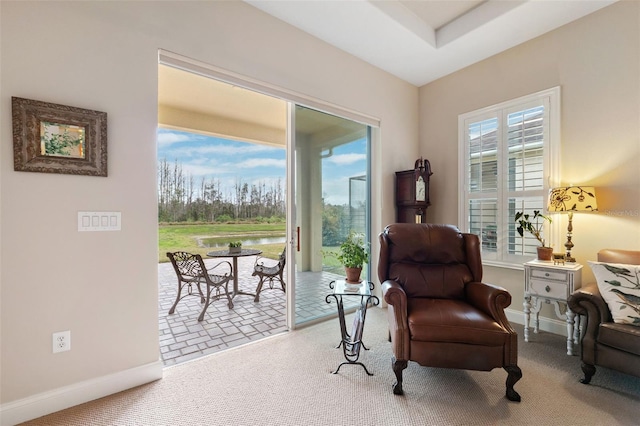 sitting room featuring a water view