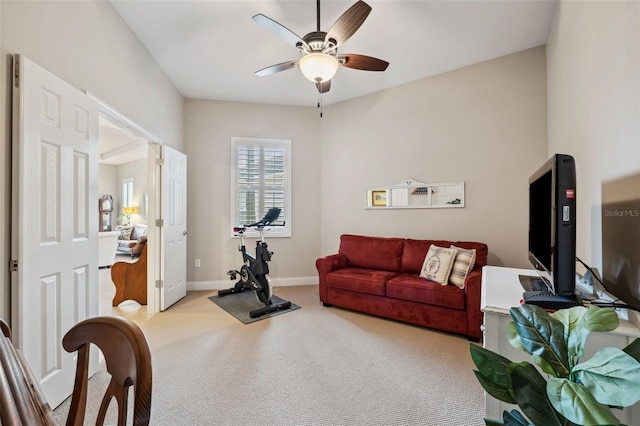 carpeted living room with ceiling fan