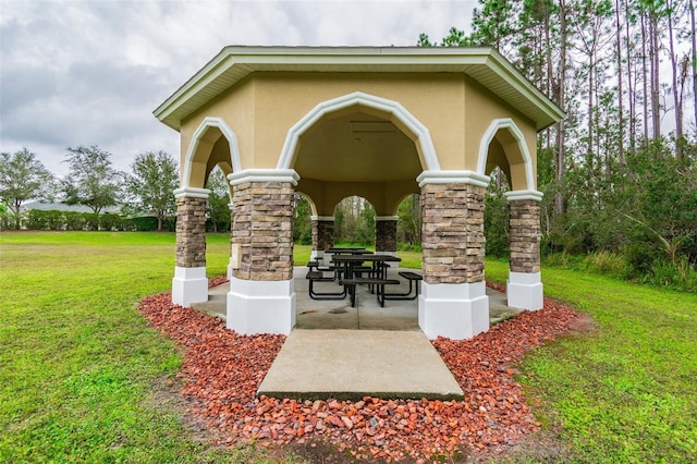 surrounding community featuring a lawn and a patio