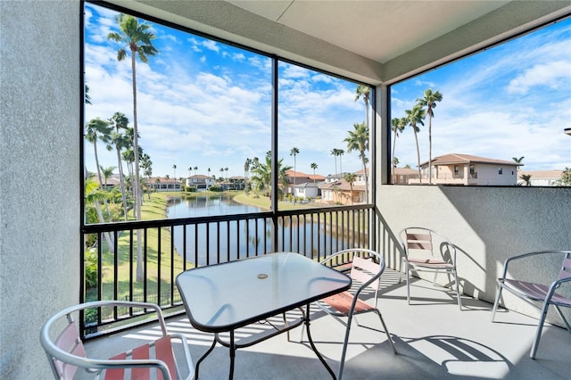 sunroom / solarium with a water view and a wealth of natural light