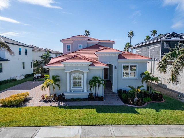 1308 Alhambra Dr, Apollo Beach, FL 33572 - mediterranean / spanish house featuring a tiled roof, stucco siding, and a front yard