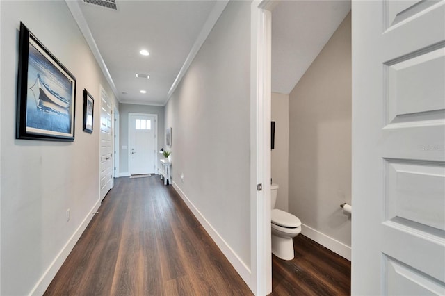 hallway with ornamental molding and dark hardwood / wood-style floors