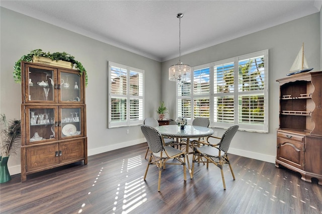 dining space featuring an inviting chandelier, ornamental molding, dark hardwood / wood-style floors, and plenty of natural light