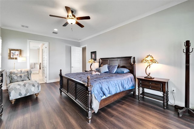 bedroom featuring ceiling fan, dark wood-type flooring, ensuite bath, and crown molding