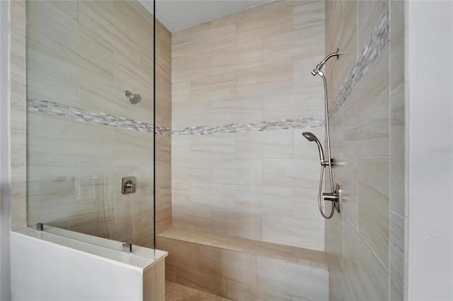 bathroom with a tile shower