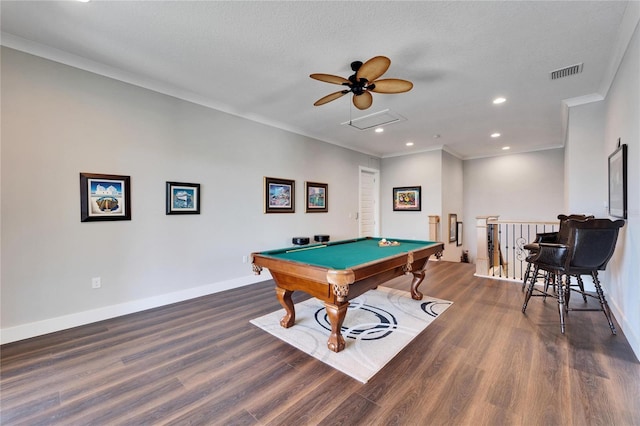 game room featuring billiards, ornamental molding, a textured ceiling, and dark wood-type flooring